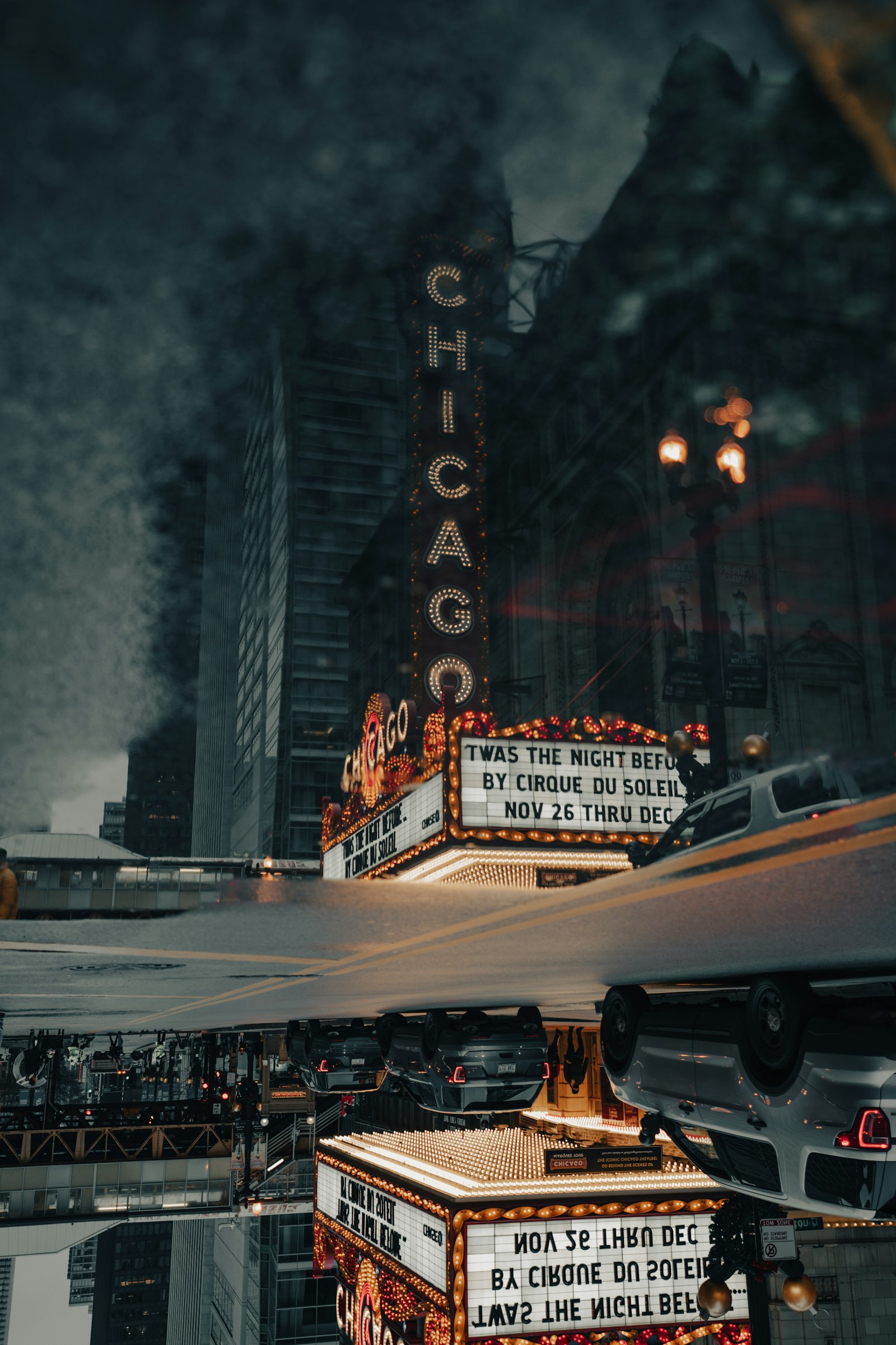 Illuminated cinema marquee glowing against a dark night sky, bold display type read from a distance