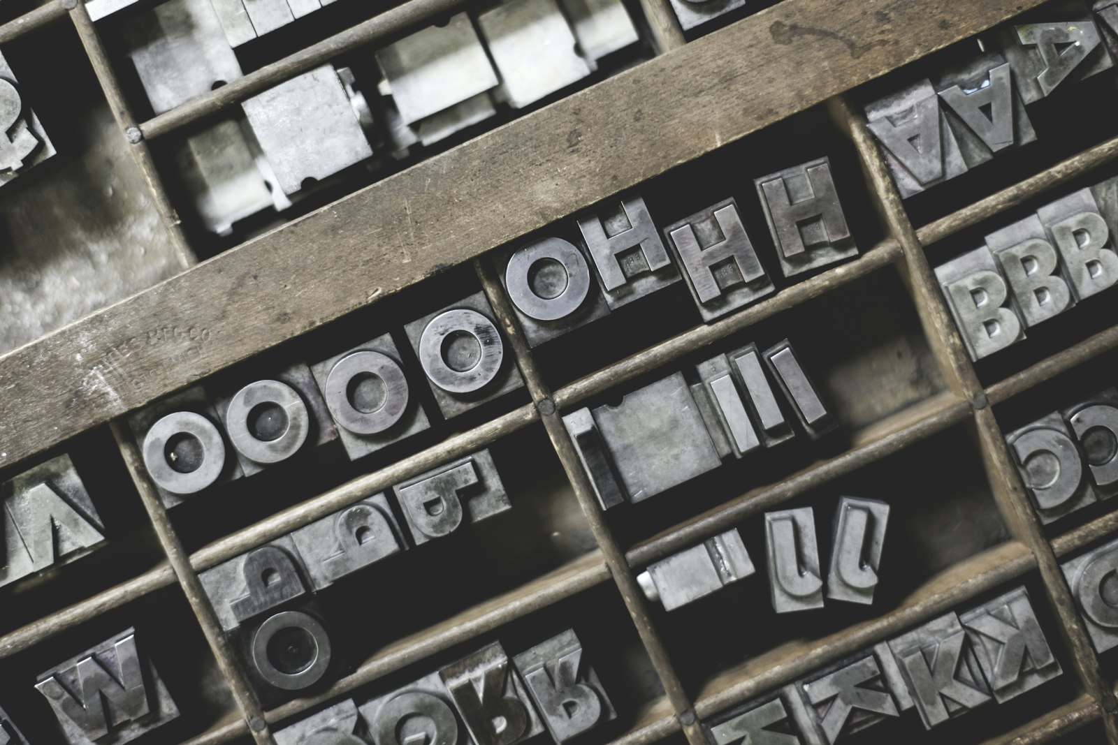 Metal letterpress type sorts in a printer's tray, the physical origin of display typefaces